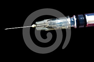 Syringe, injection needle on black background
