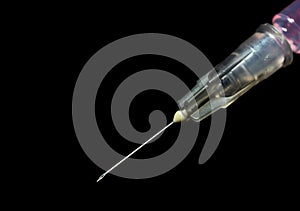 Syringe, injection needle on black background