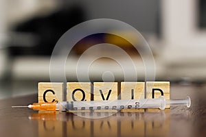 Syringe and inscription covid-19. Covid-19 coronavirus vaccination concept. A new strain of the virus threatens a worldwide