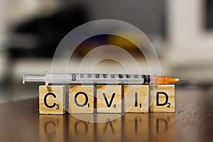 Syringe and inscription covid-19. Covid-19 coronavirus vaccination concept. A new strain of the virus threatens a worldwide