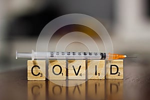 Syringe and inscription covid-19. Covid-19 coronavirus vaccination concept. A new strain of the virus threatens a worldwide