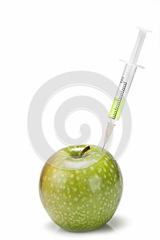 Syringe inserted in an apple.
