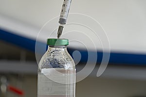 Syringe inside saline in the infirmary. Close up