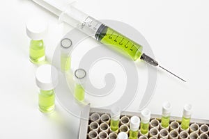 Syringe loaded with green liquid on labortory worktop