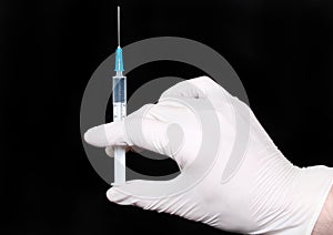 Syringe in medical gloves hand, injection.