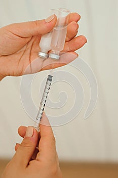 Syringe, medical injection in hand, palm or fingers. Medicine plastic vaccination equipment with needle