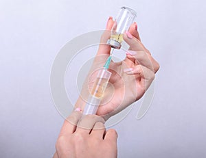 Syringe, medical injection in hand, palm or fingers. Medicine plastic vaccination equipment with needle. Nurse doctor