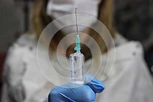 Syringe, medical injection in hand, palm or fingers. Nurse or doctor. Liquid drug or narcotic. Health care in hospital