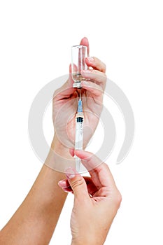 Syringe with a medicine in a female hands, isolated on white