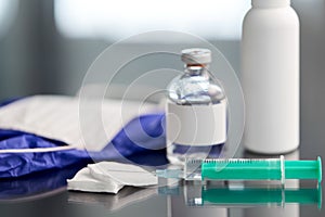 Syringe, medicine, wound wipes, gloves and mask