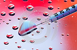 Syringe needle with fluid drops