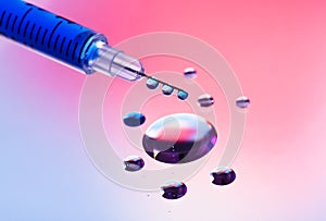 Syringe needle with fluid drops