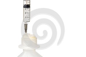 A syringe with a needle stuck in a plastic bottle. Objects are isolated on a white background. Saline bottle. Medicine and