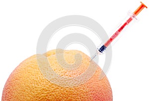 Syringe and orange.
