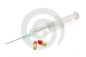 Syringe and pills, isolated