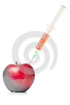 Syringe in red apple