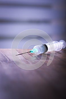 Syringe on table with blur