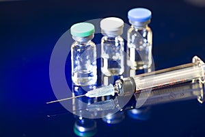 Syringe And Three Medication Vials