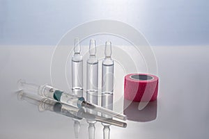 A syringe and three vials