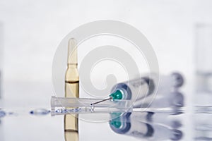 Syringe with transparent liquid and ampule