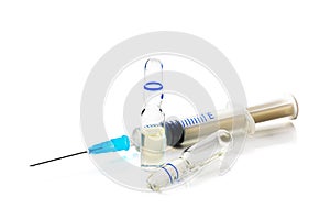 Syringe and two ampoules on white background