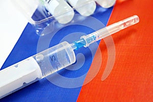 Syringe with a vaccine  on background of the Russian Federation flag, vaccine against coronavirus