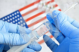 Syringe with a vaccine is held by  hand in a glove on background of the Russian Federation flag