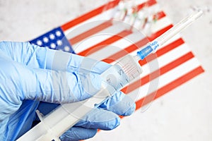 syringe with a vaccine is held by hand in a glove on background of the Russian Federation flag