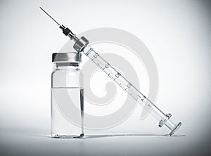 Syringe with vial of medication closeup photo