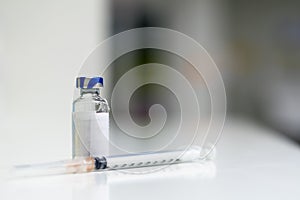 Syringe and vial of medicine.