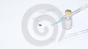 Syringe and vile on prescription pad