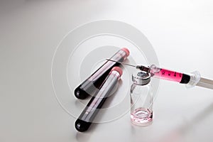 Syringe with  vitamin B12 and ampoule from it, pills and blood flasks