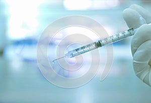 Syringe with white pill capsule background in science lab