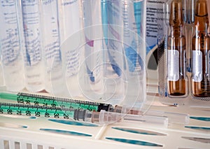 Syringes, ampoules with medicine, saline on a shelf. Medical background for business, pharmacies, hospitals photo