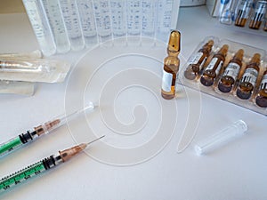 Syringes, ampoules, saline on a white background. Medical background for business, pharmacies, clinics, hospitals.