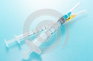 Syringes on blue background.