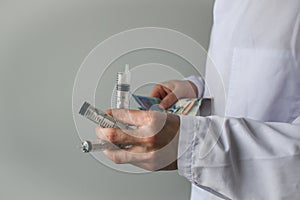 Syringes and money in doctor's hands