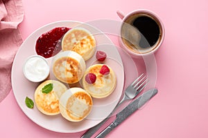 Syrniki, cottage cheese fritters on plate top view