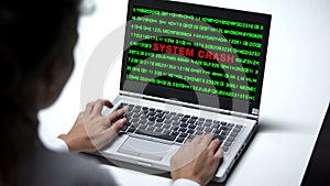 System crash on laptop computer, woman working in office, data hack, cybercrime