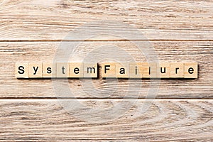 System failure word written on wood block. system failure text on table, concept