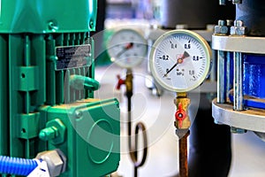 System of hot water pipes with manometer in boiler room