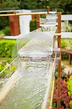 System of water cascade made of glass gutters photo