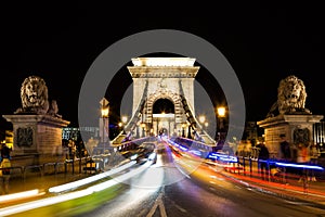 Szechenyi Chain Bridge with colorful light trails by night in the city of Budapest, Hungary