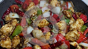 Szechuan chicken stir fry being cooked in a Teflon pan
