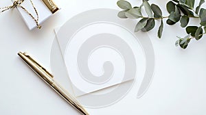 A minimalistic composition on a white surface features a blank white card