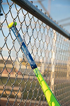 T-ball baseball bat hanging on dugout fence photo