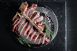 T bone steak is grilled sliced on a piece. Aged Barbecue Porterhouse Steak American meat restaurant served on slate board. banner