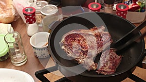T-bone steak grilling in non stick pan