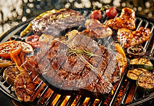 T-bone steak grilling over a portable barbecue