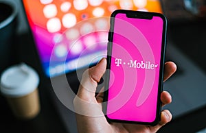 T-mobile logo on the smartphone screen in hand